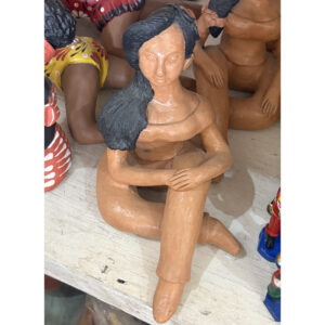 Handmade clay sculpture of a Bahian woman inspired by Morena de Itapuã, featuring authentic Brazilian folk art craftsmanship by Olaria TTY. raffia objects home decor